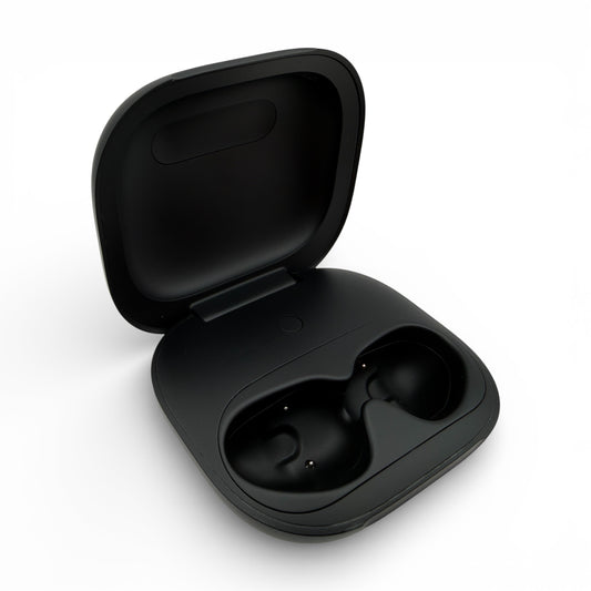 Beats Powerbeats Fit charging case in black, opened to reveal the earbud charging slots