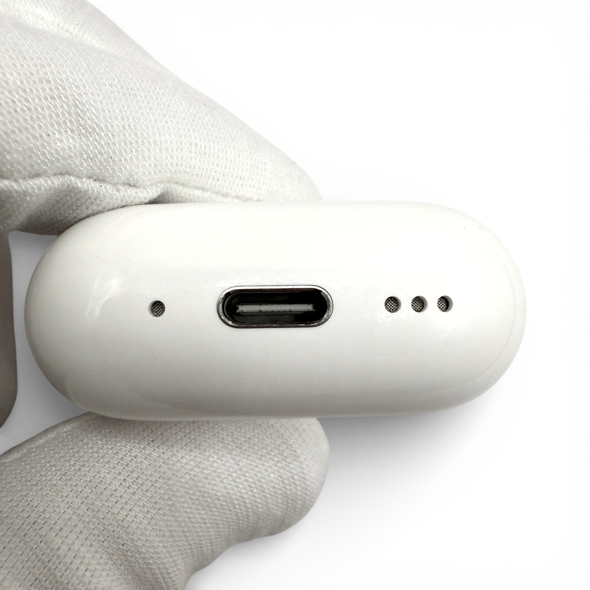 Apple AirPods 4 charging case with ANC, underside showing USB-C port between mic hole and speaker grille