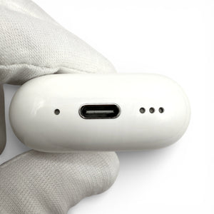Apple AirPods 4 charging case with ANC, underside showing USB-C port between mic hole and speaker grille