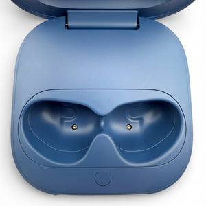 Beats Fit Pro charging case in blue, open showing the earbud charging cradles
