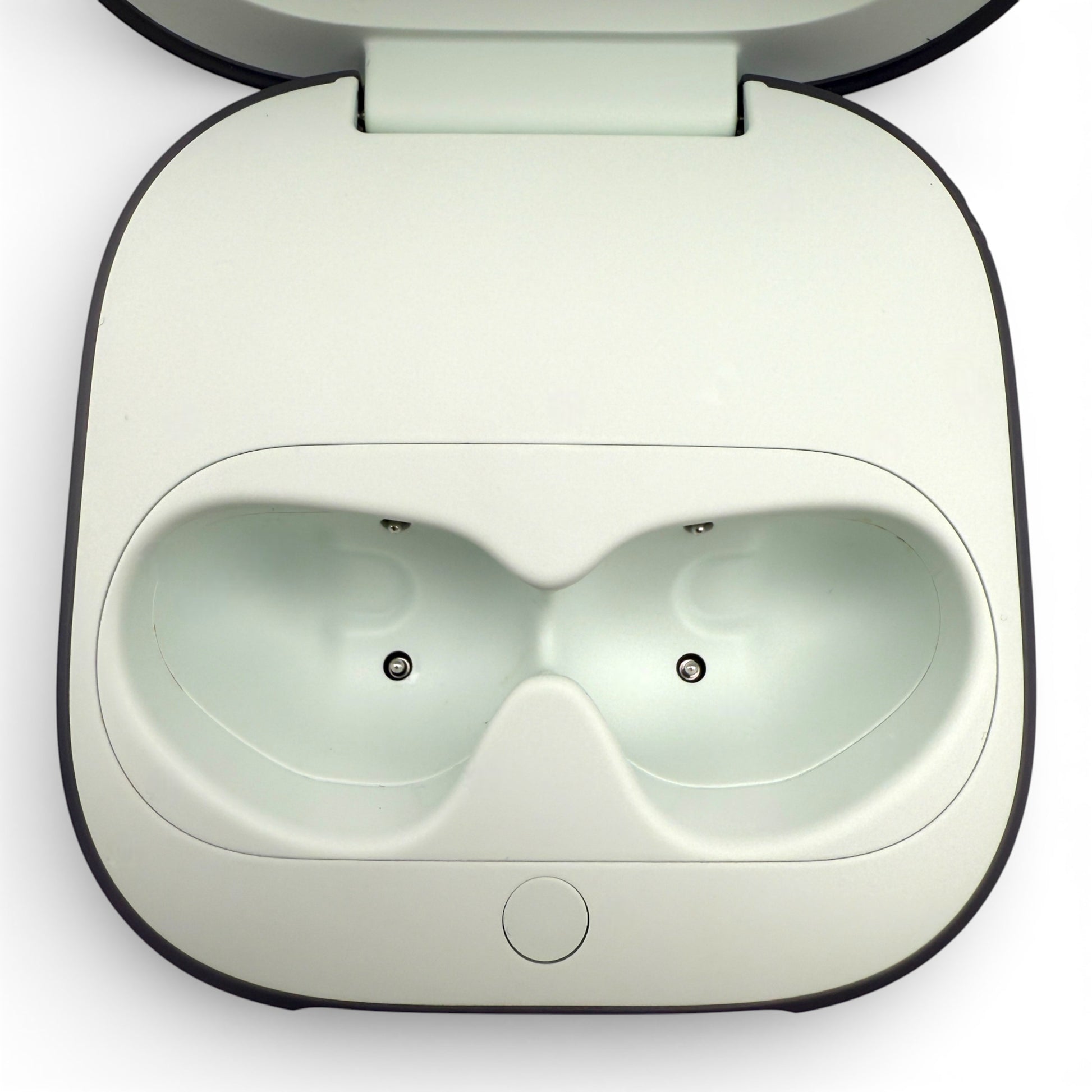 Beats Fit Pro charging case in gray, open showing the earbud charging cradles