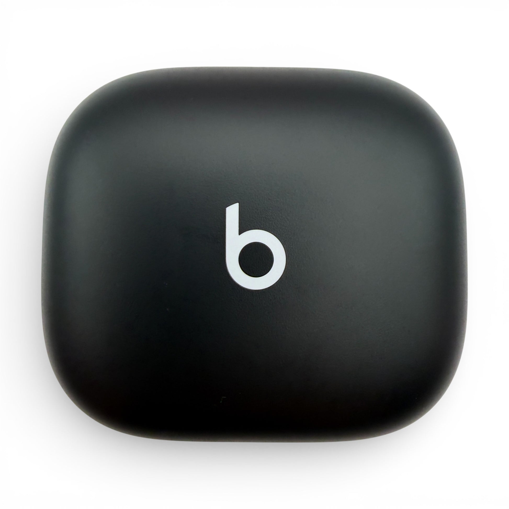 Beats Powerbeats Fit charging case in black, top-down view of the closed lid