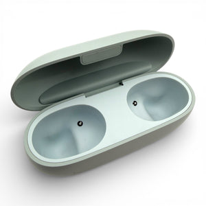 Beats Solo Buds charging case in gray, open showing the two empty earbud charging bays