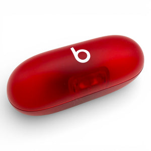 Beats Solo Buds charging case in red, closed lid at an angle showing the translucent shell