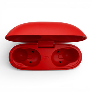 Beats Studio Buds charging case in red, opened showing the empty earbud slots