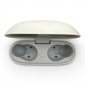Beats Studio Buds charging case in white, opened showing the empty earbud slots