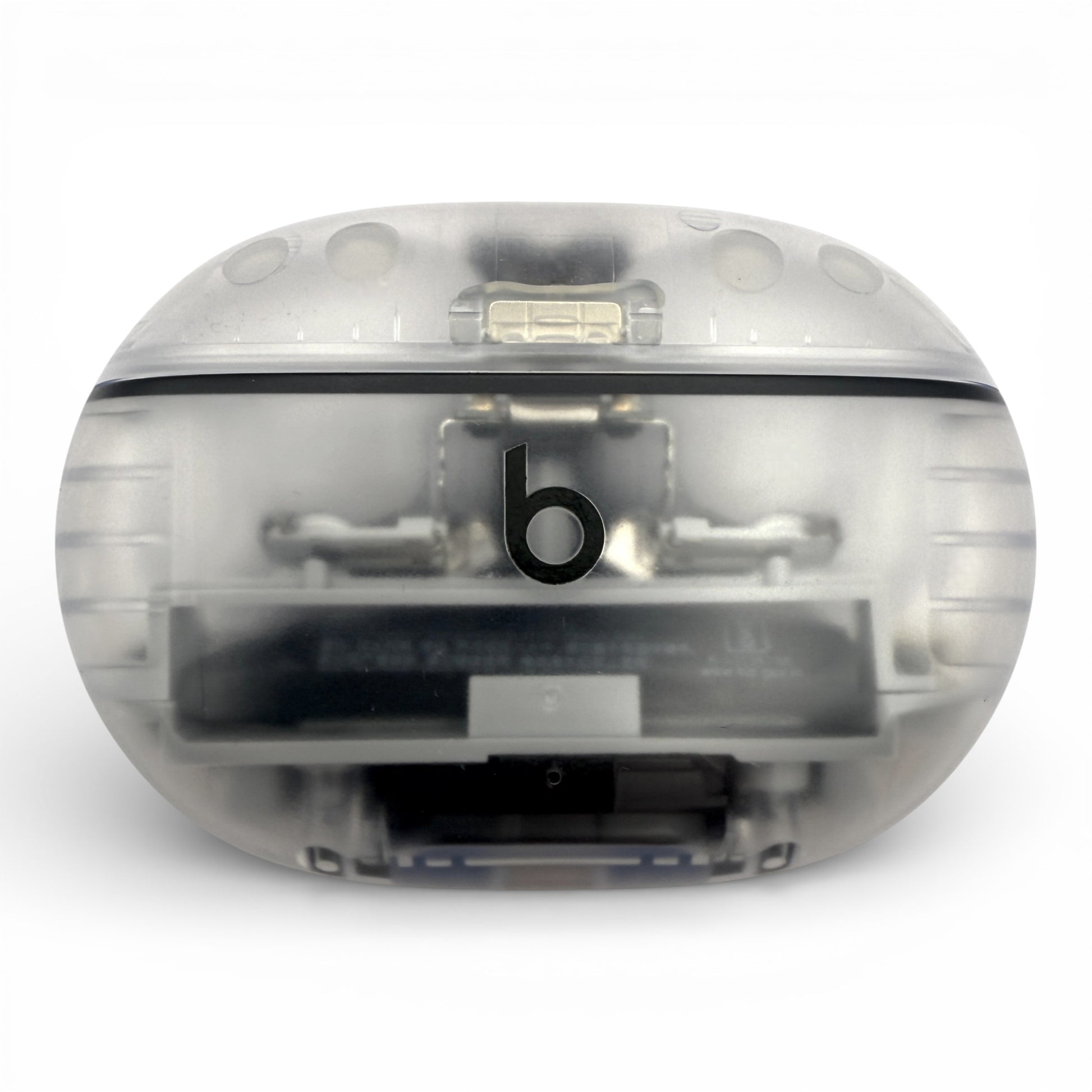 Beats Studio Buds+ charging case in clear, closed front view with internals visible through the shell