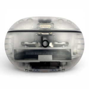 Beats Studio Buds+ charging case in clear, closed front view with internals visible through the shell