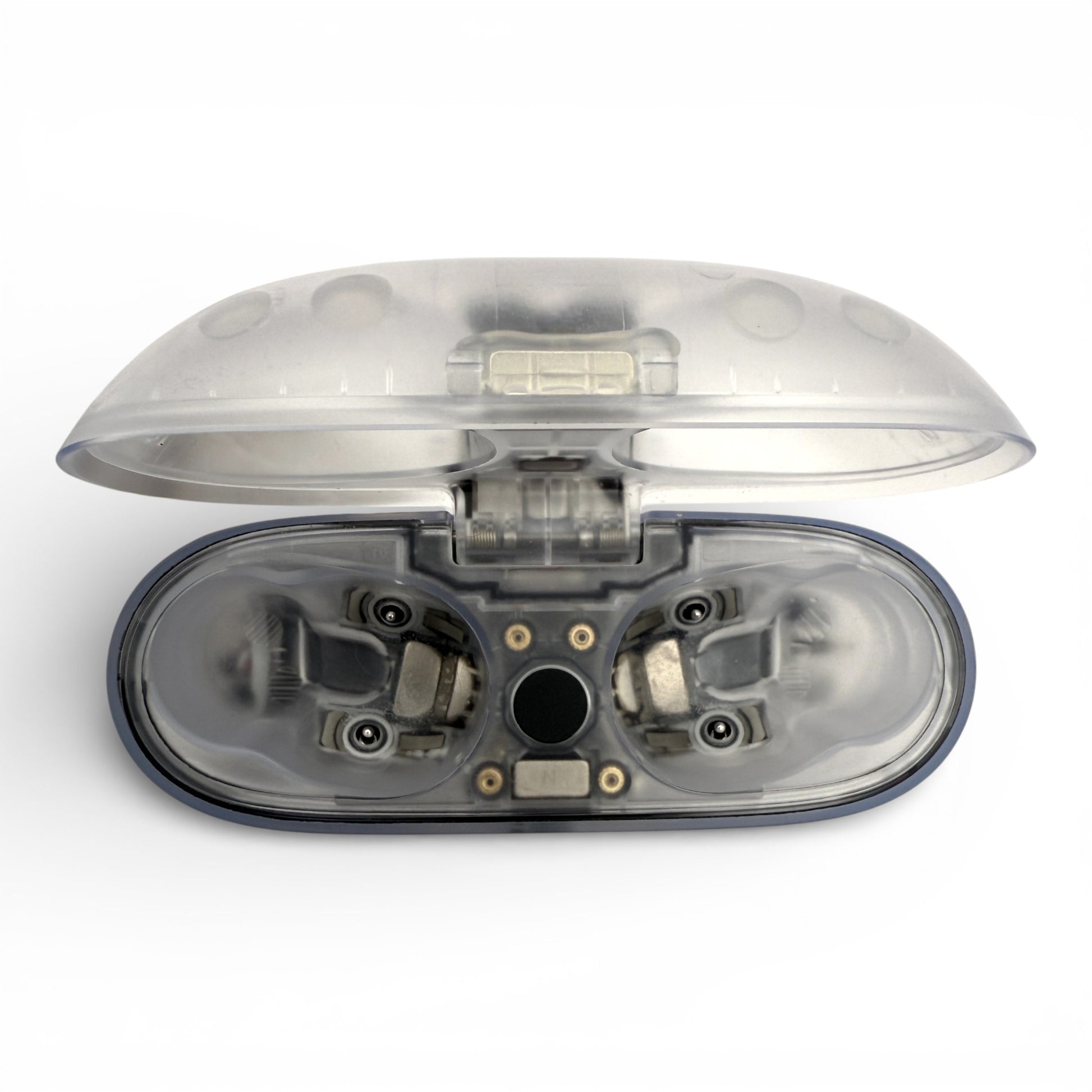 Beats Studio Buds+ charging case in clear, open lid revealing empty earbud slots and internal wiring