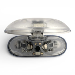 Beats Studio Buds+ charging case in clear, open lid revealing empty earbud slots and internal wiring