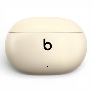 Beats Studio Buds+ charging case in ivory, closed front view showing the logo and LED indicator
