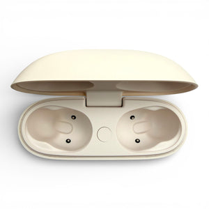 Beats Studio Buds+ charging case in ivory, open lid revealing two empty earbud slots