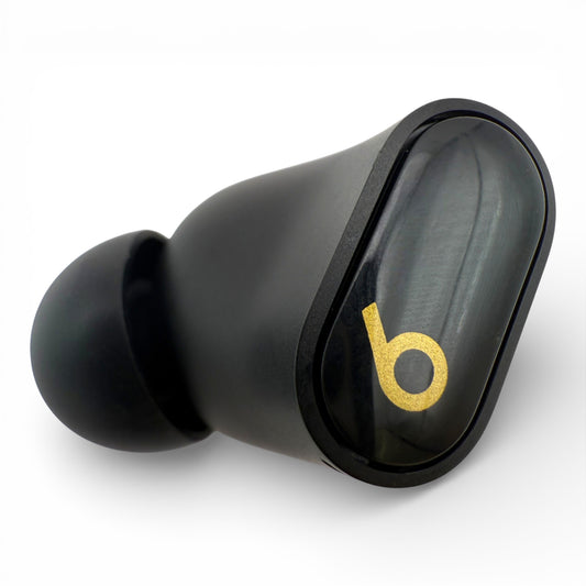 Left Beats Studio Buds+ earbud in black, top view showing the logo and ear tip