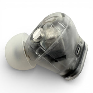 Left Beats Studio Buds+ earbud in clear, side view showing the charging contact