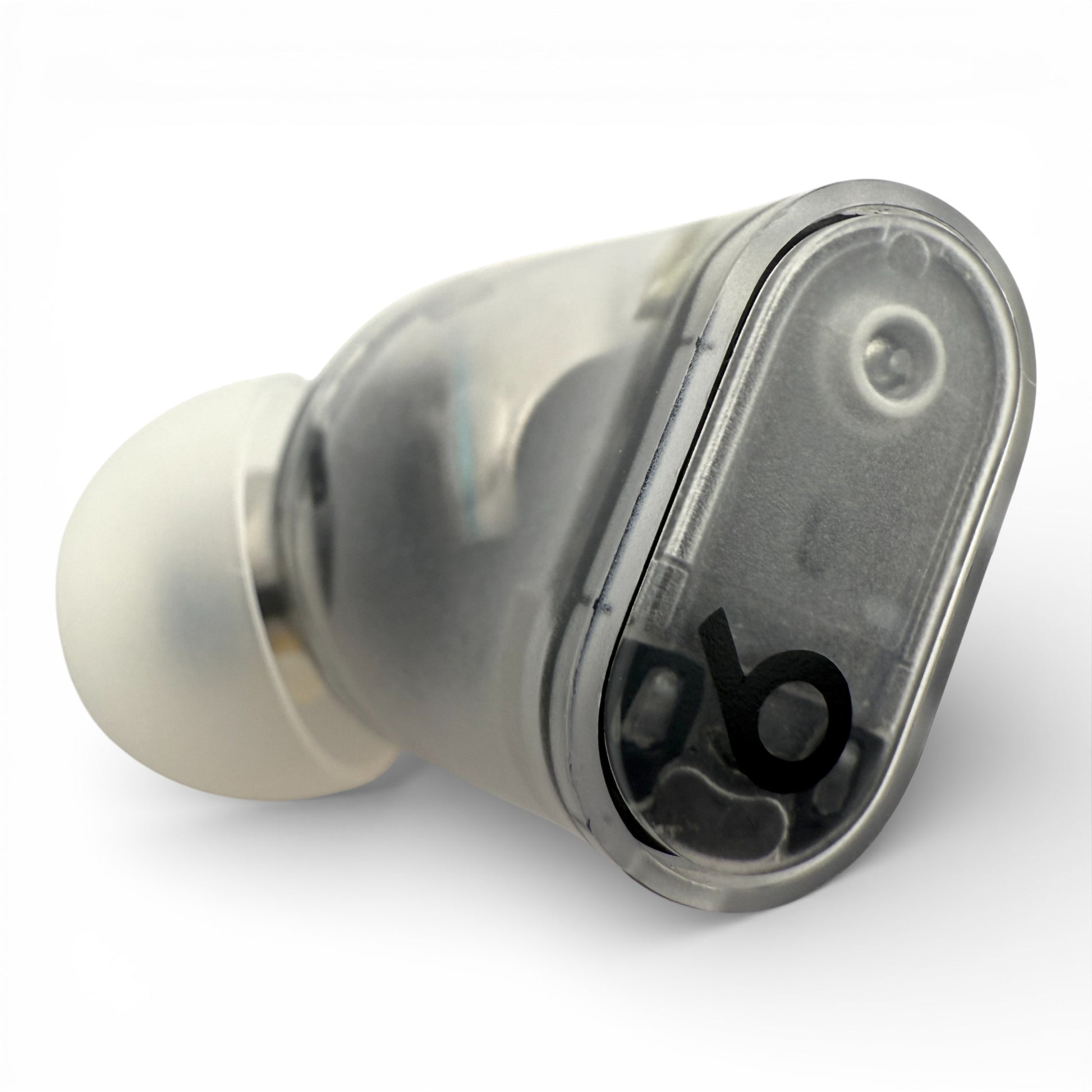 Left Beats Studio Buds+ earbud in clear, top view showing the translucent shell and logo