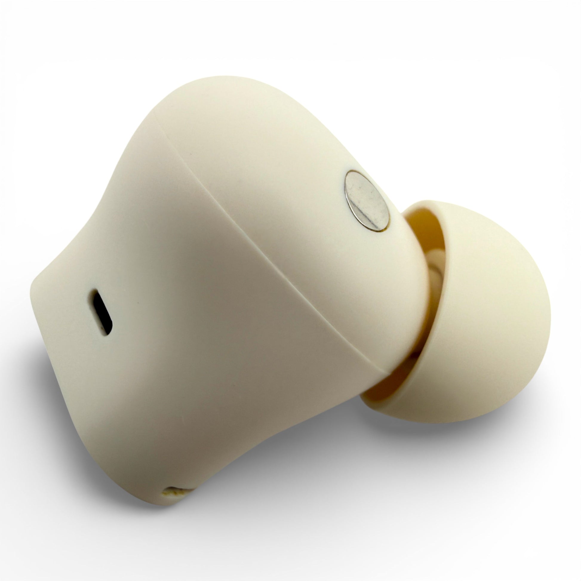 Left Beats Studio Buds+ earbud in ivory, side view showing the charging contact