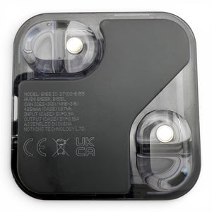Nothing ear (2) charging case in black, interior view showing charging contacts and regulatory text