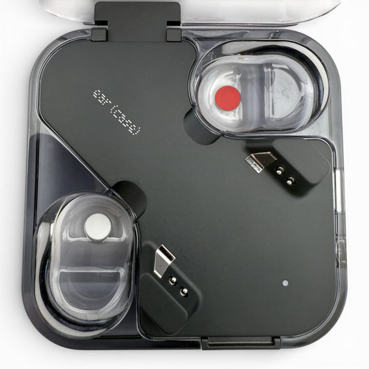 Nothing ear (2) charging case in black, open showing the earbud cavities and USB-C port