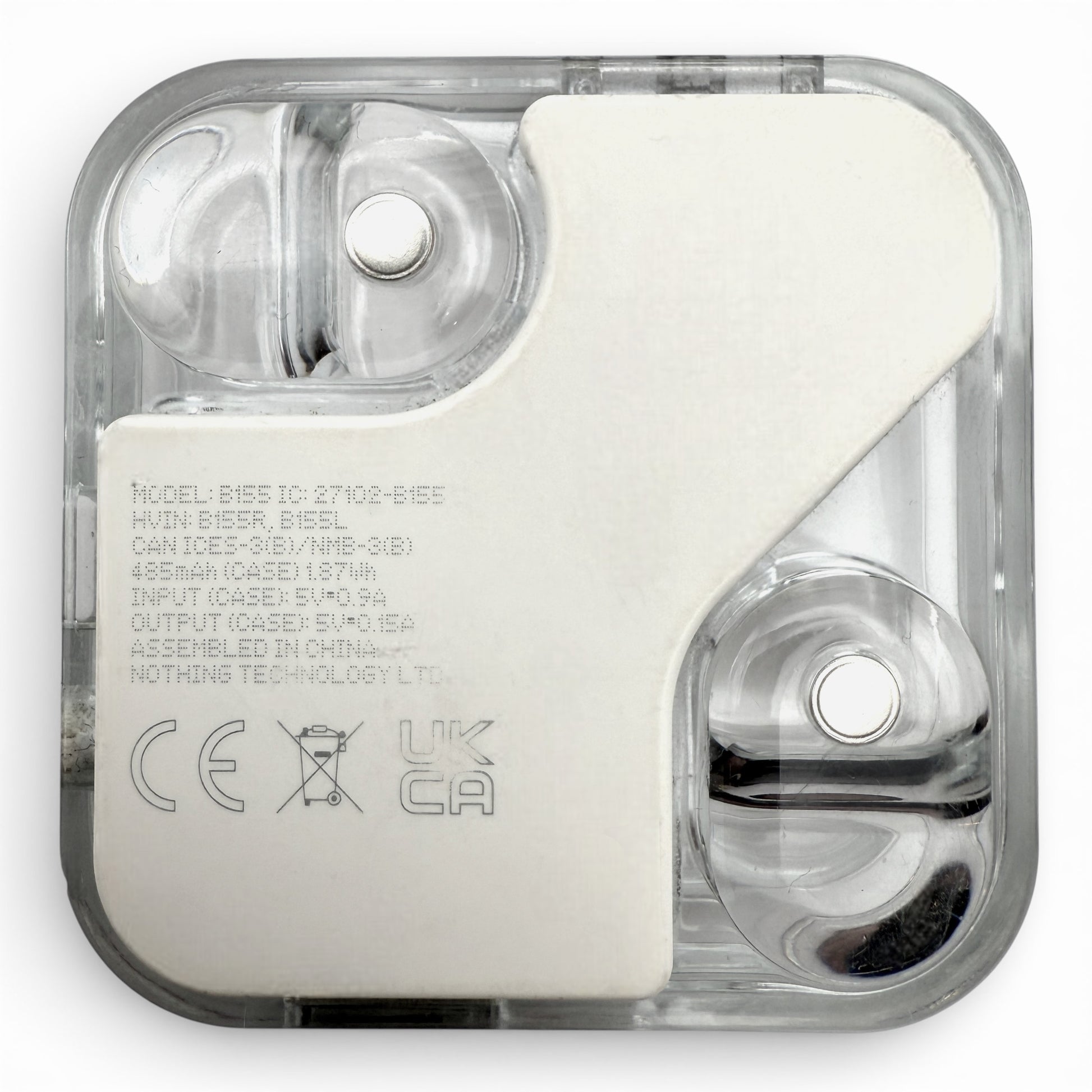 Nothing ear (2) charging case in white, interior view showing charging contacts and regulatory text