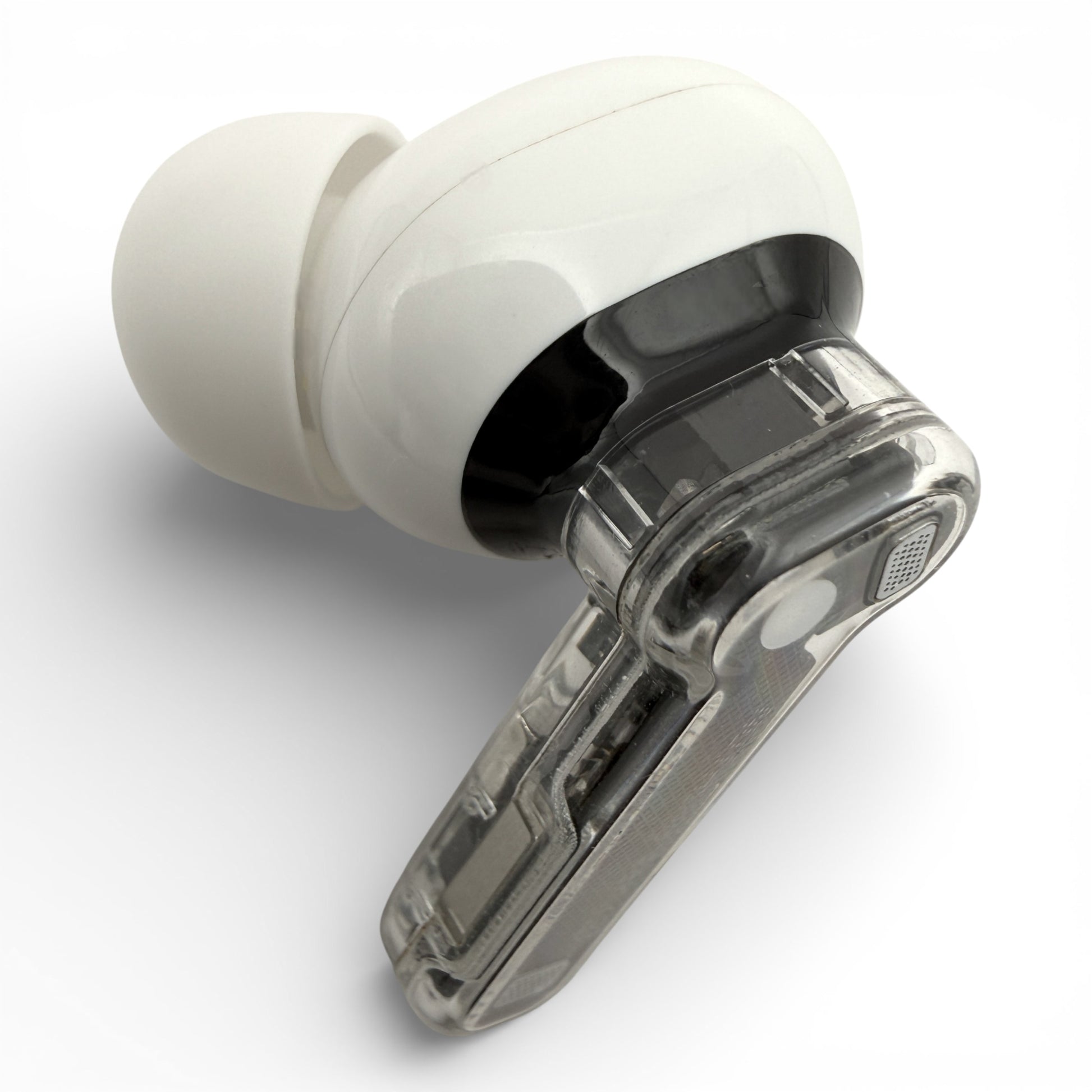 Left Nothing ear (2) earbud in white, front view showing the ear tip and transparent stem with charging contacts