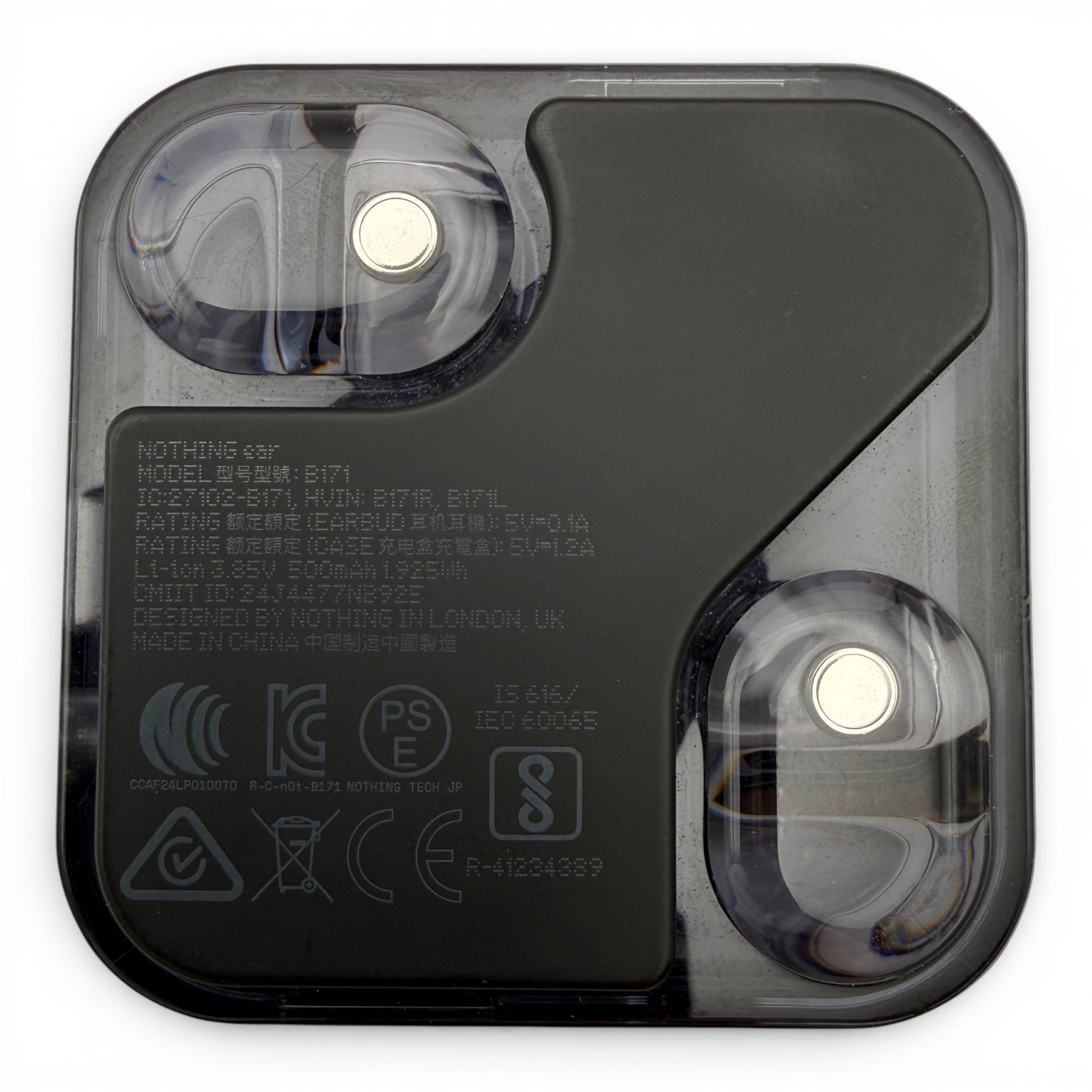 Nothing ear charging case in black, underside view showing the earbuds and product information label