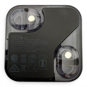 Nothing ear charging case in black, underside view showing the earbuds and product information label
