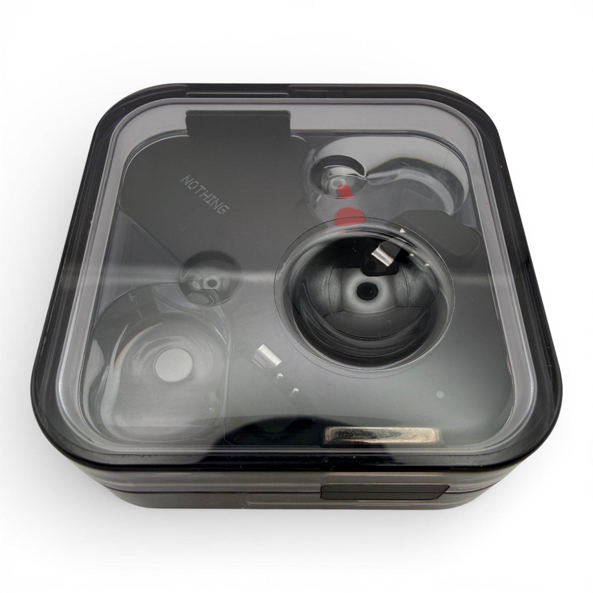 Nothing ear charging case in black, closed lid view with the earbuds visible through the transparent top