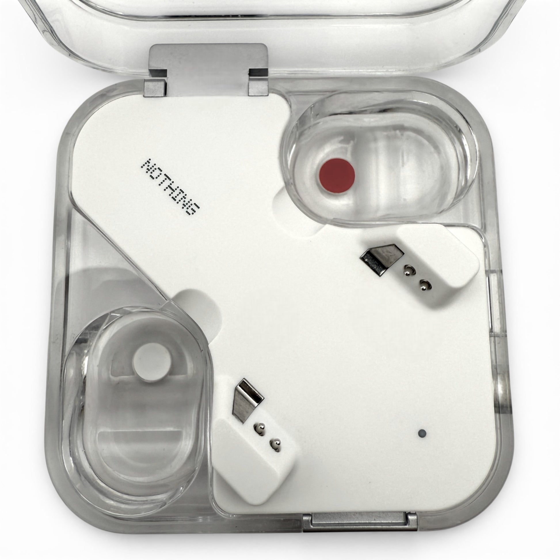 Nothing ear charging case in white, open view showing both earbuds seated inside with charging pins visible