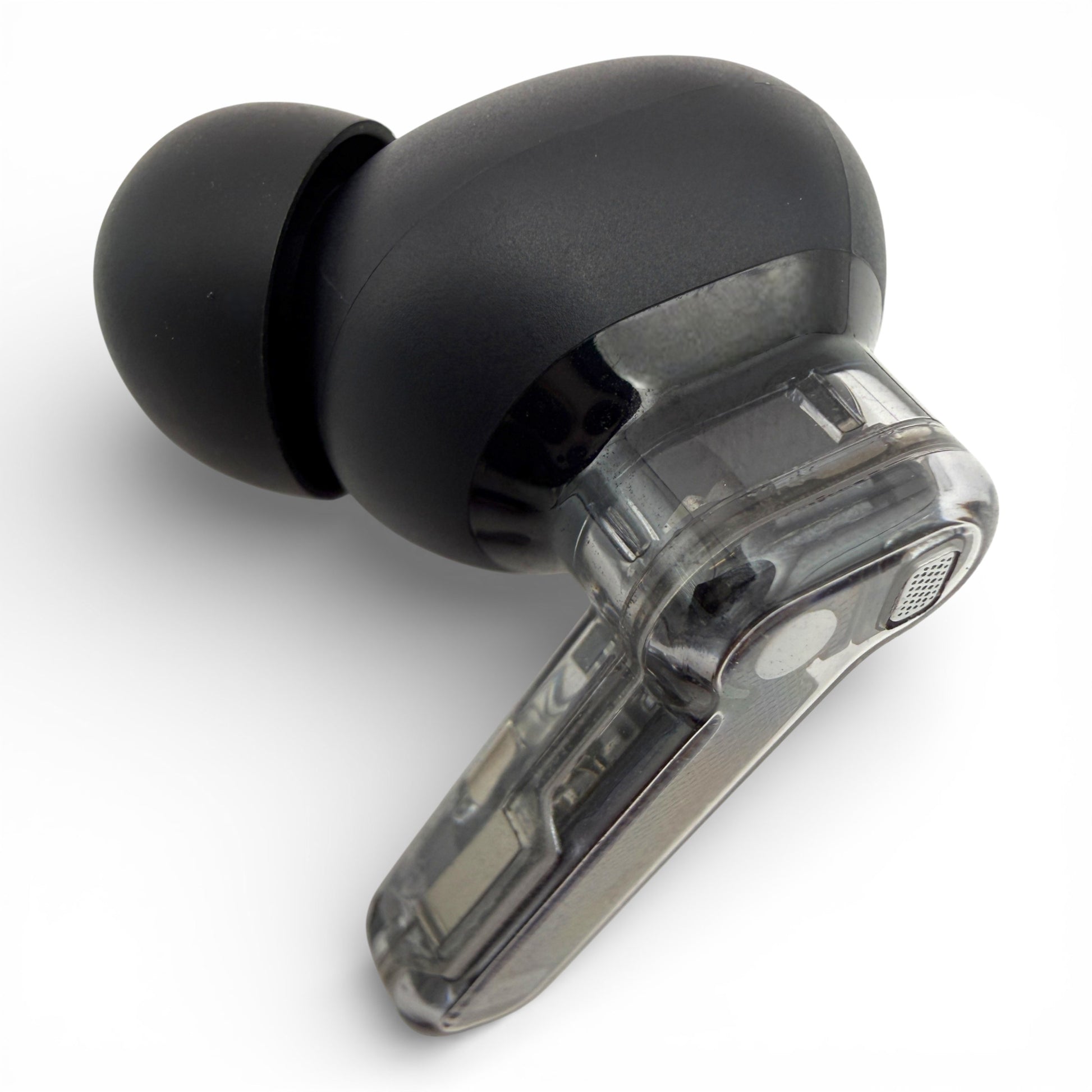 Left Nothing ear earbud in black, front view showing the ear tip and transparent stem with charging contacts